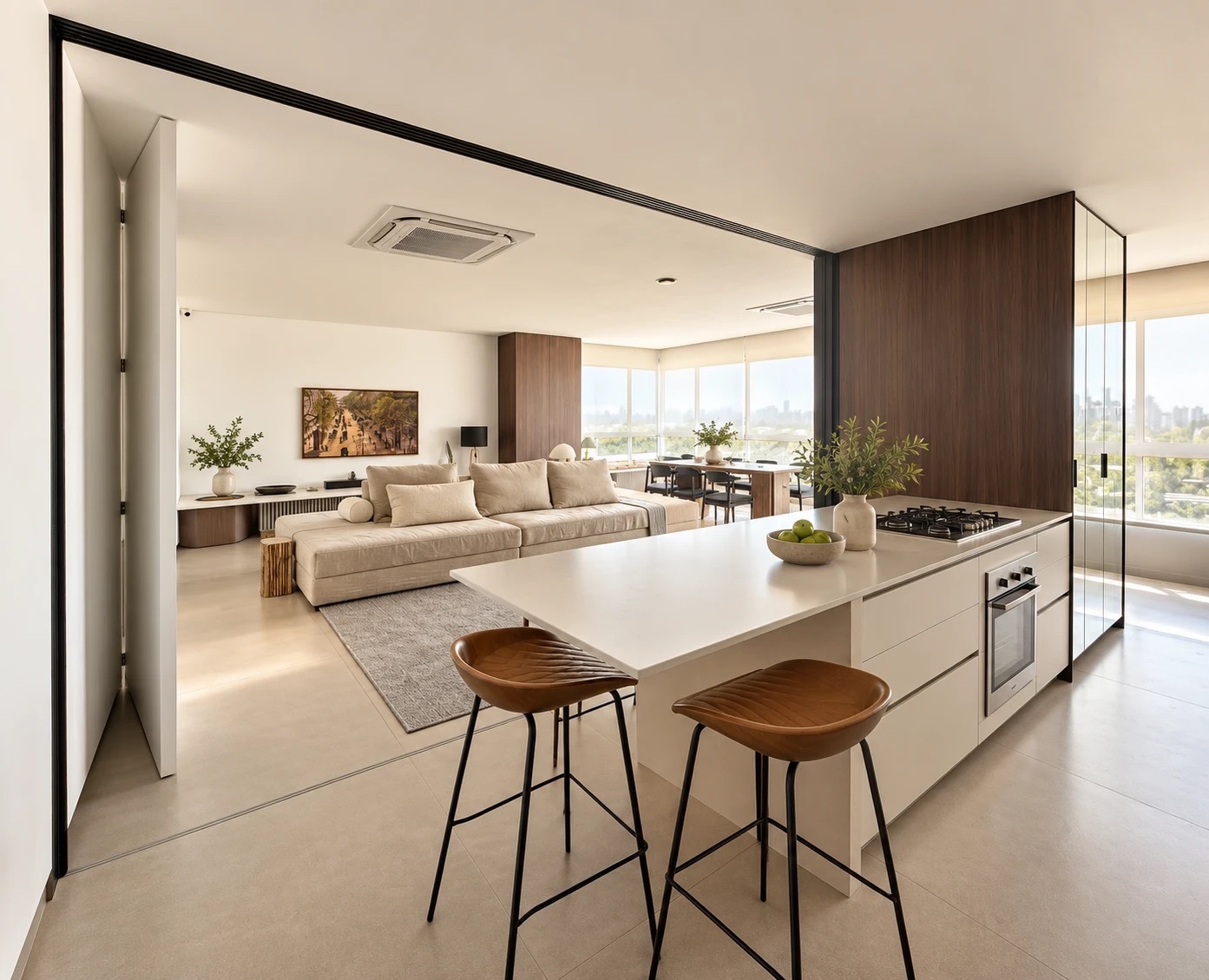 An open high-rise apartment: kitchen island, living room and windows onto the city